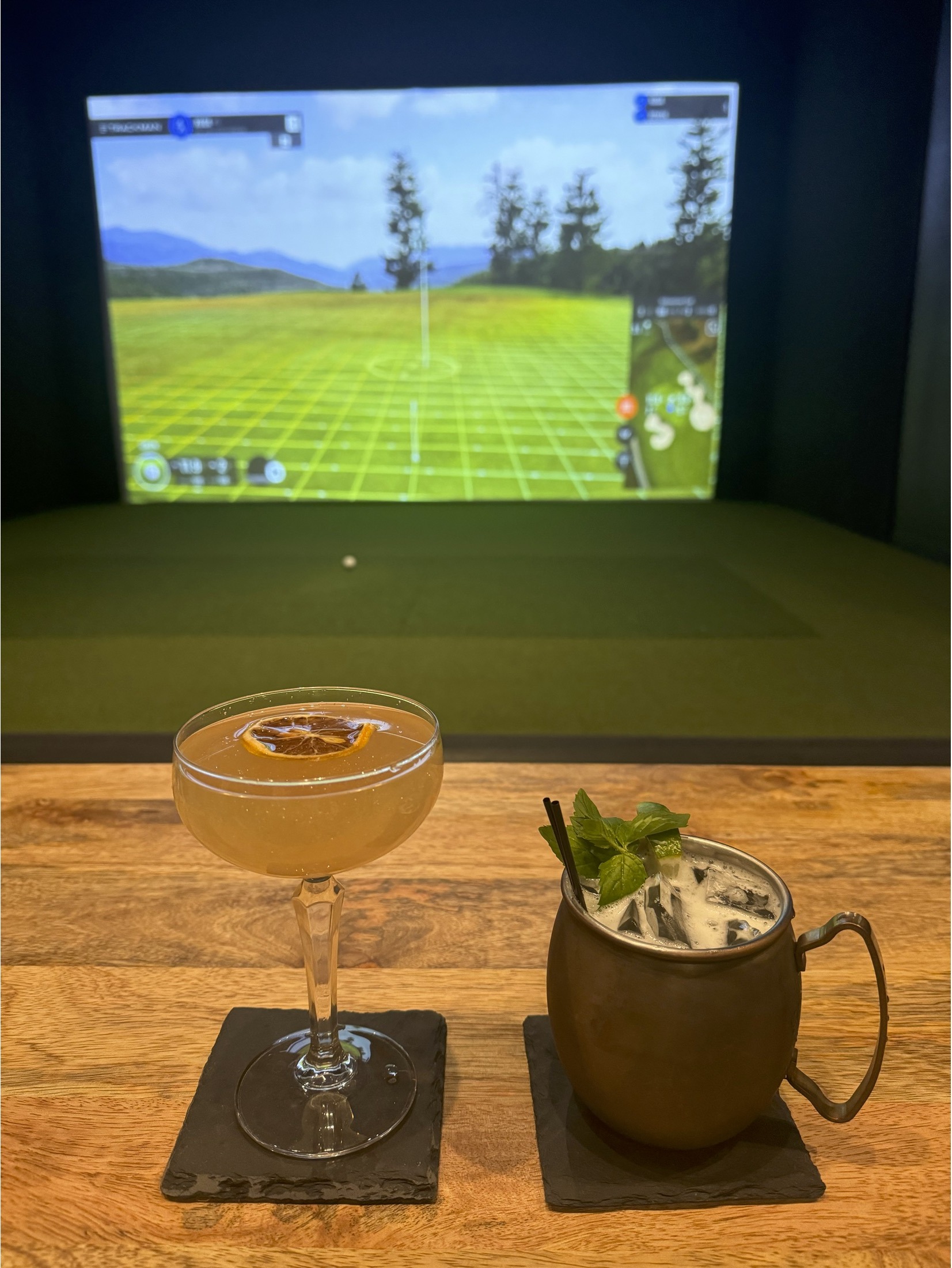 Craft cocktails in front of the Golf Lodge simulator
