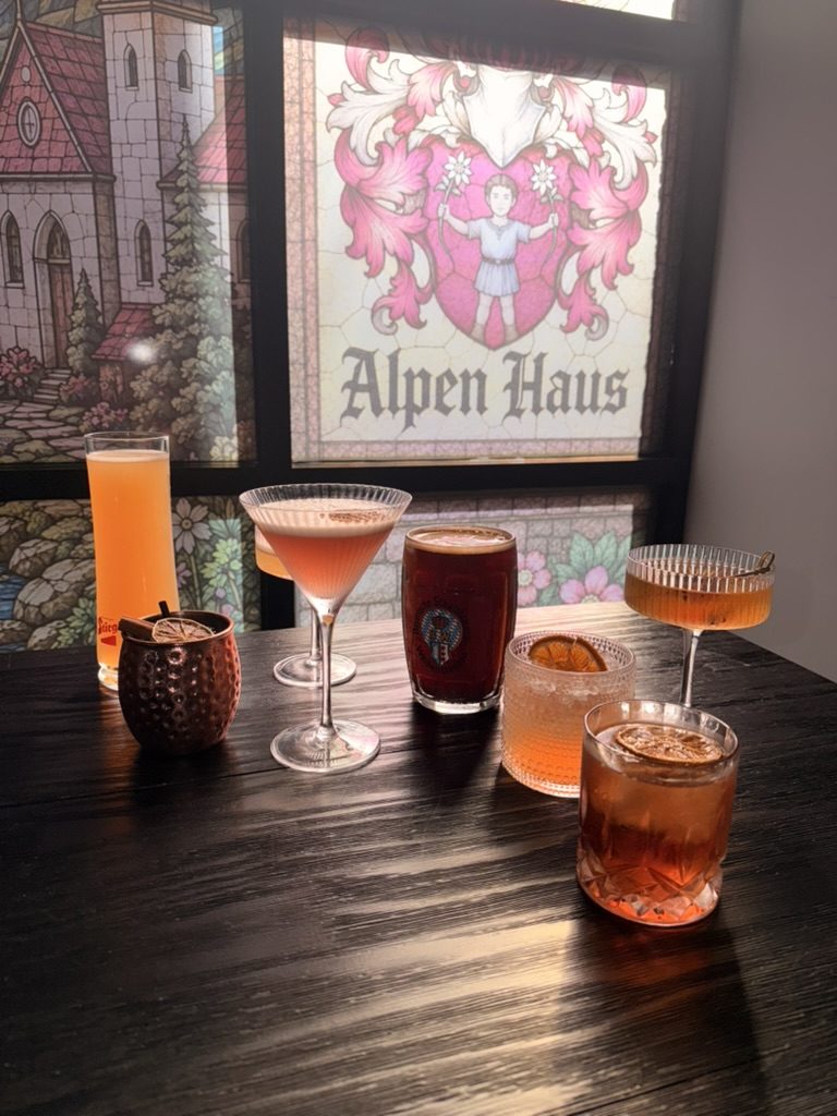 Cocktails under the Alpen Haus crest